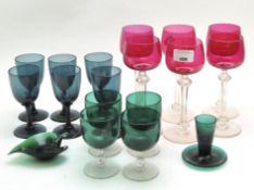 A large collection of cranberry and green wine glasses, 20th century, of various sizes,