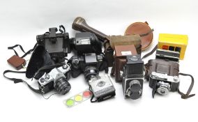 A collection of vintage cameras and equipment, including a Super Ricohflex, Pentax, Kodak and more,