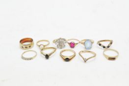 Eleven gold dress rings set with semi-precious stones,