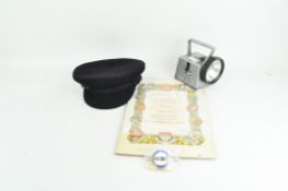 A collection of London Transport related items to include torch, hat and badges.