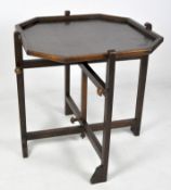 A reversable foldable card table, the wooden frame of octagonal form with a green felt insert,