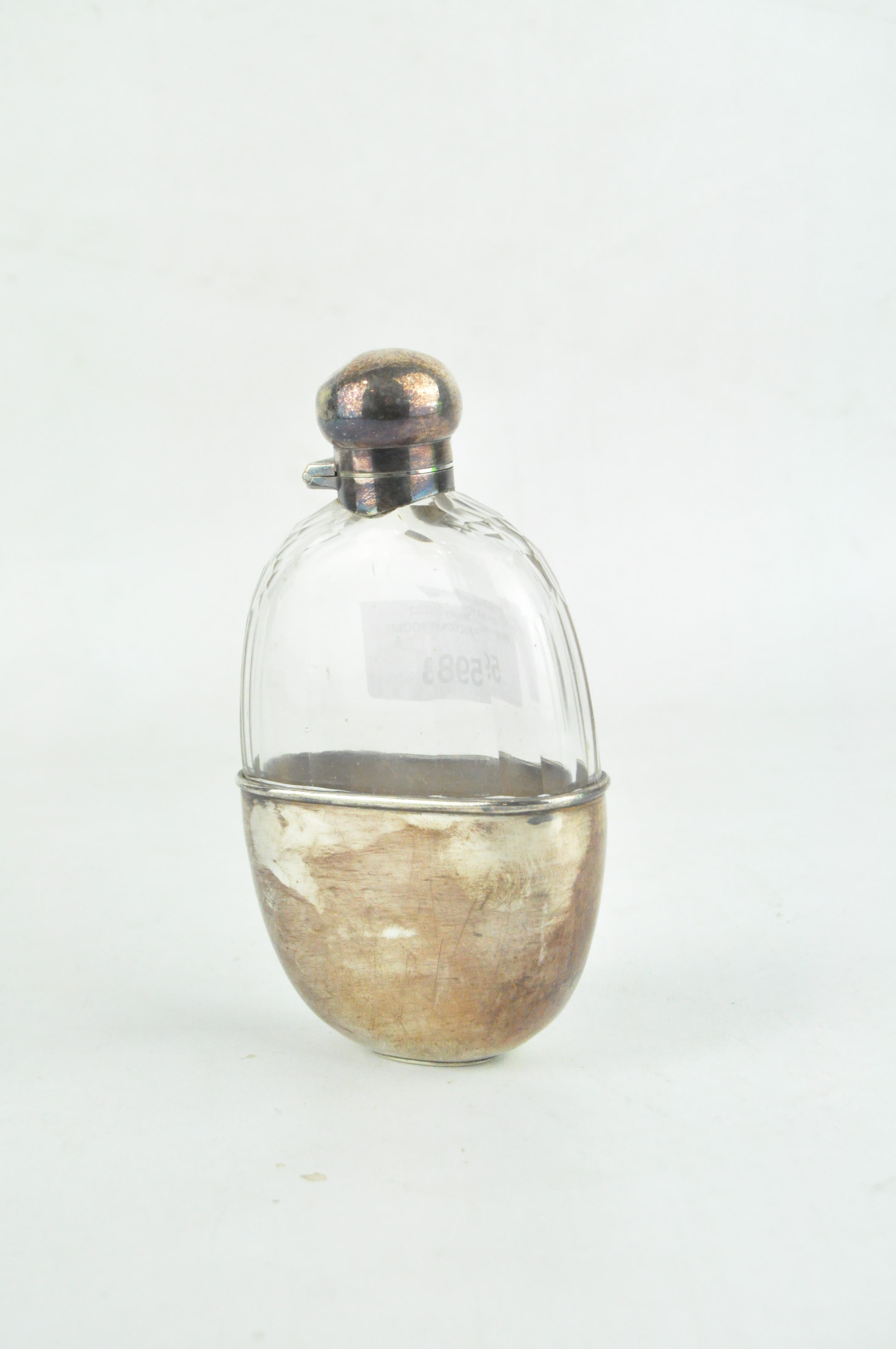 A early 20th century silver plated glass hip flask,