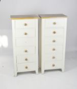 A pair of modern cream painted tall chests of drawers, with pine handles and tops,