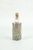 An Edwardian glass scent bottle in a silver case,
