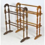 Two early 20th century wooden free standing towel rails. Each approximately 62cm x 76cm.