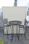 Vintage black painted metal garden bar table with two high chairs with pierced foilate decoration