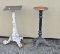 Two cast metal table bases of tripod form,