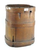 An early 20th century wooden rice bucket/umbrella stand, of rectangular form with rounded edges,