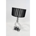 A contemporary chromed table lamp,