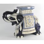 A large glazed ceramic jardiniere stand in the form of an Asian elephant,