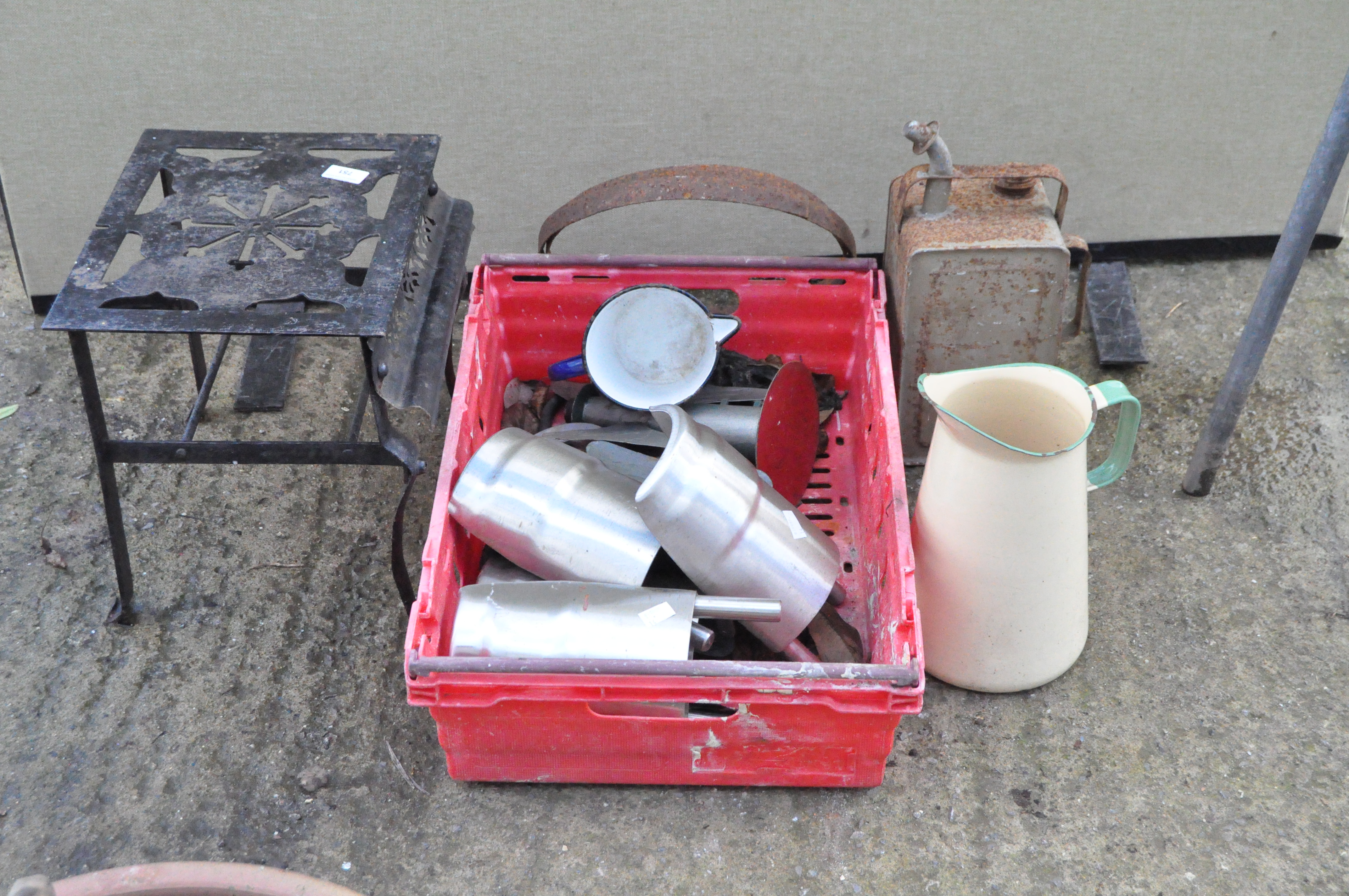 Assorted metalwares, including door stop, enamel pouring jug, fuel can, and more