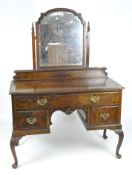 A Victorian mahogany dressing table with attached swing mirror,