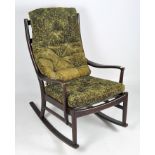 A Parker Knoll rocking chair, the wooden frame holding two green upholstered cushions,