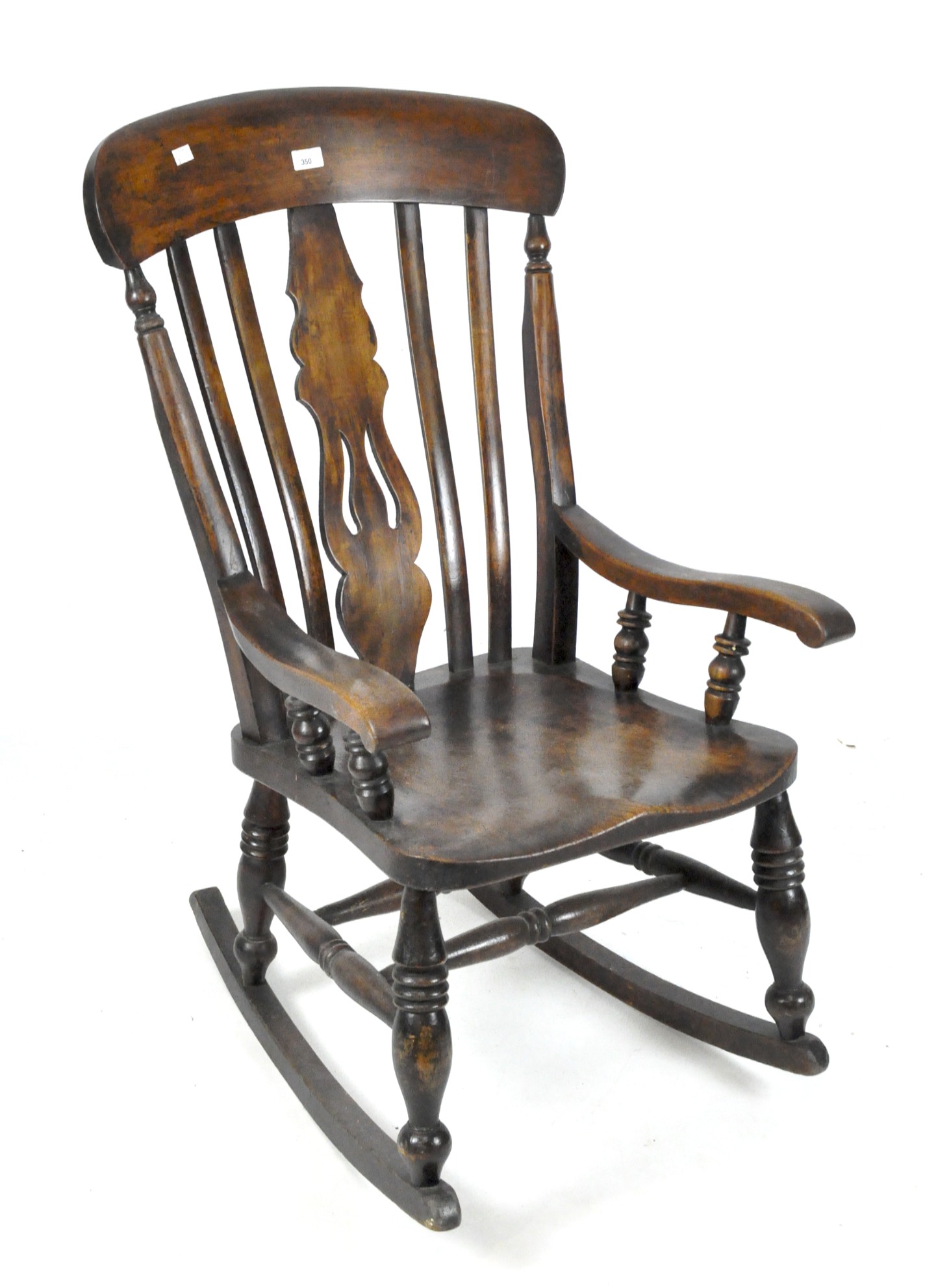 A Victorian fiddle back rocking chair and a footstall,