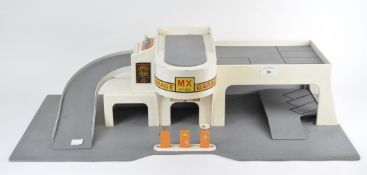 A vintage toy garage, the wooden structure marked 'MX Petrol',