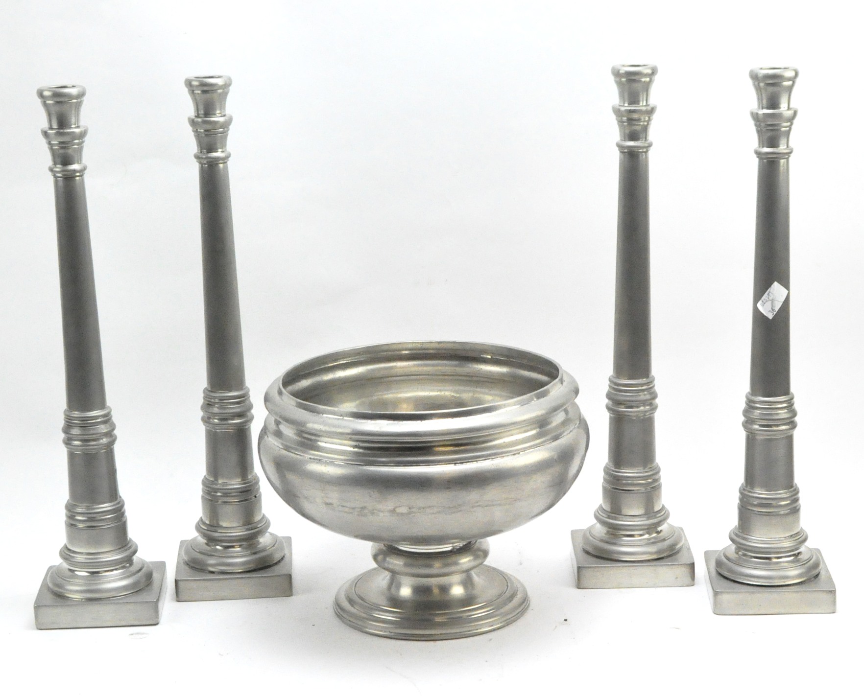 Four large white metal column candlesticks by Giovanni Patrini and a footed circular bowl,