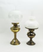 Two early 20th century oil lamps with glass shades and funnels,