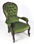 A late 19th/early 20th century button back armchair,