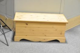A contemporary pine blanket box with a collection of UK ordnance survey and road maps,