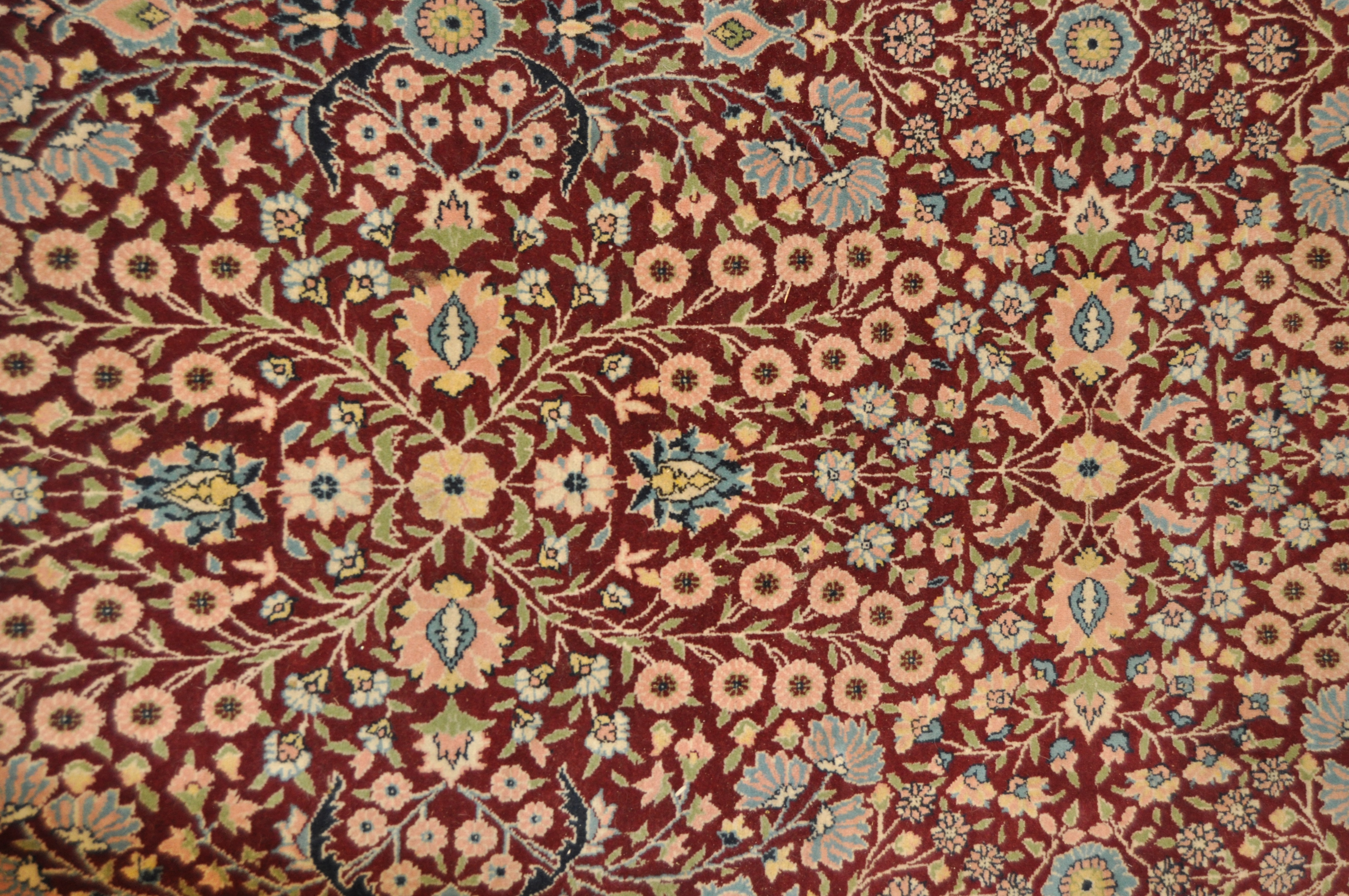 A 20th century Turkish rug, woven with dense flowers on a dark red ground, - Image 7 of 7
