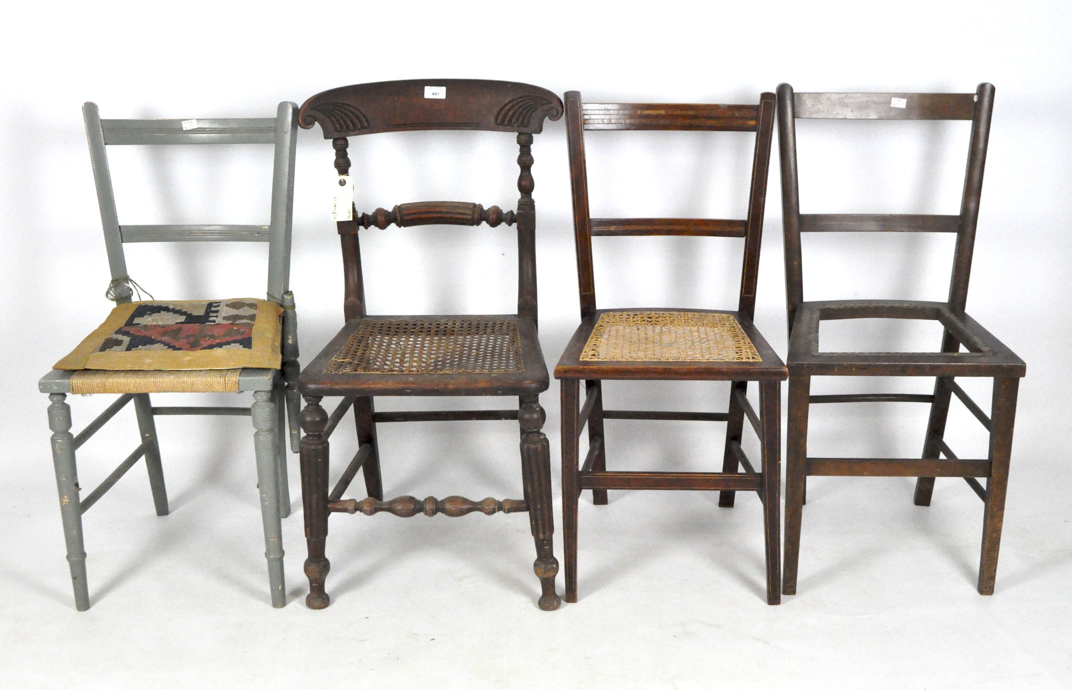 A selection of four dining chairs, two with caned seats, another grey painted,