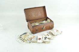 A collection of cigarette cards, including Willis's and Players, in a miniature trunk