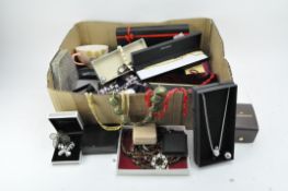 A large collection of costume jewellery, including brooches, watches and scent bottles