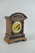 A Continental oak early 20th century striking mantle clock