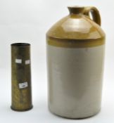A brass ammunition shell case and a large stoneware flagon,