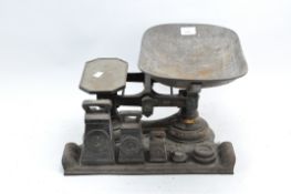 A set of cast metal kitchen scales and weights,