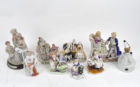 A collection of ceramic figures, late 19th/early 20th century, including a Dresden figure group,