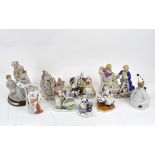 A collection of ceramic figures, late 19th/early 20th century, including a Dresden figure group,