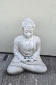 A large garden stone model of a seated Buddha,
