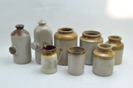 A group of beige stoneware storage pots,