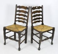 Two ladderback dining chairs with rush seating,