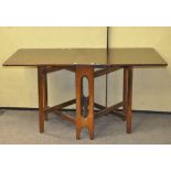 A 20th century mahogany drop leaf table, with pierced supports and rounded edges,