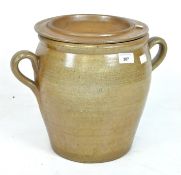 A large French Gres de Bonny salt glazed pot and lid, of honey colour, with two strap handles,