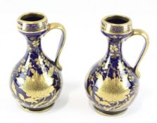 A pair of 19th century Staffordshire glazed ceramic ewers,