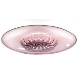 A large coloured glass dish of circular form,