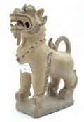 A 20th century Chinese pottery figure of a dog,