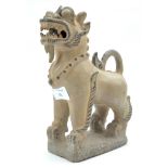 A 20th century Chinese pottery figure of a dog,