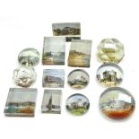 A collection of early 20th century glass paperweights, all featuring British tourist destinations,