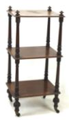 A Victorian three tier whatnot, on turned supports and raised on castors, 87cm x 40cm x 33.