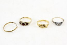 Four 9ct gold rings, one a diamond solitaire, another set with diamonds,