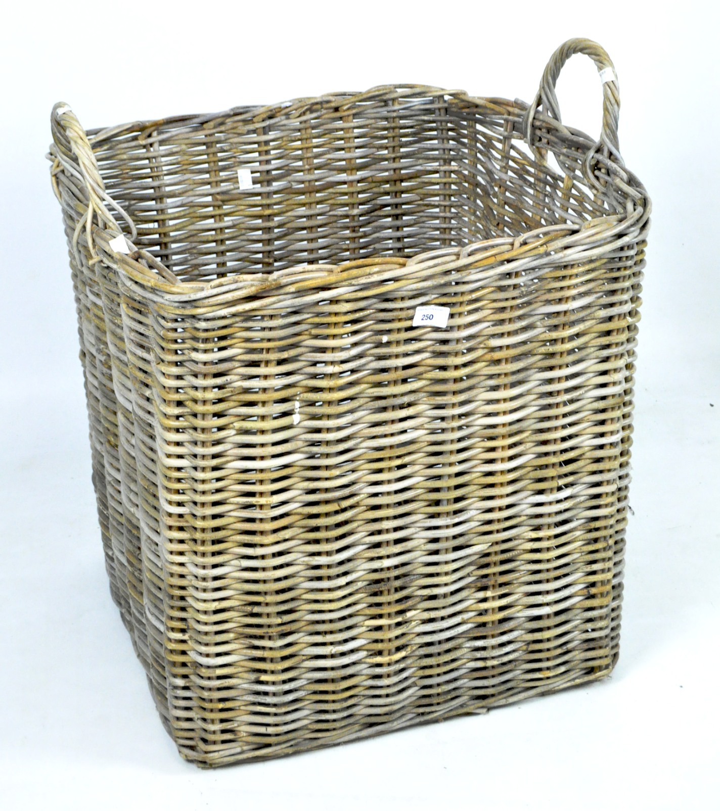 A large twin handled wicker storage basket,