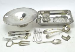 A group of silver plated wares to include a tazza, rectangular dish, cutlery, sugar tongs,
