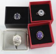 Four ladies silver dress rings, set with assorted stones,