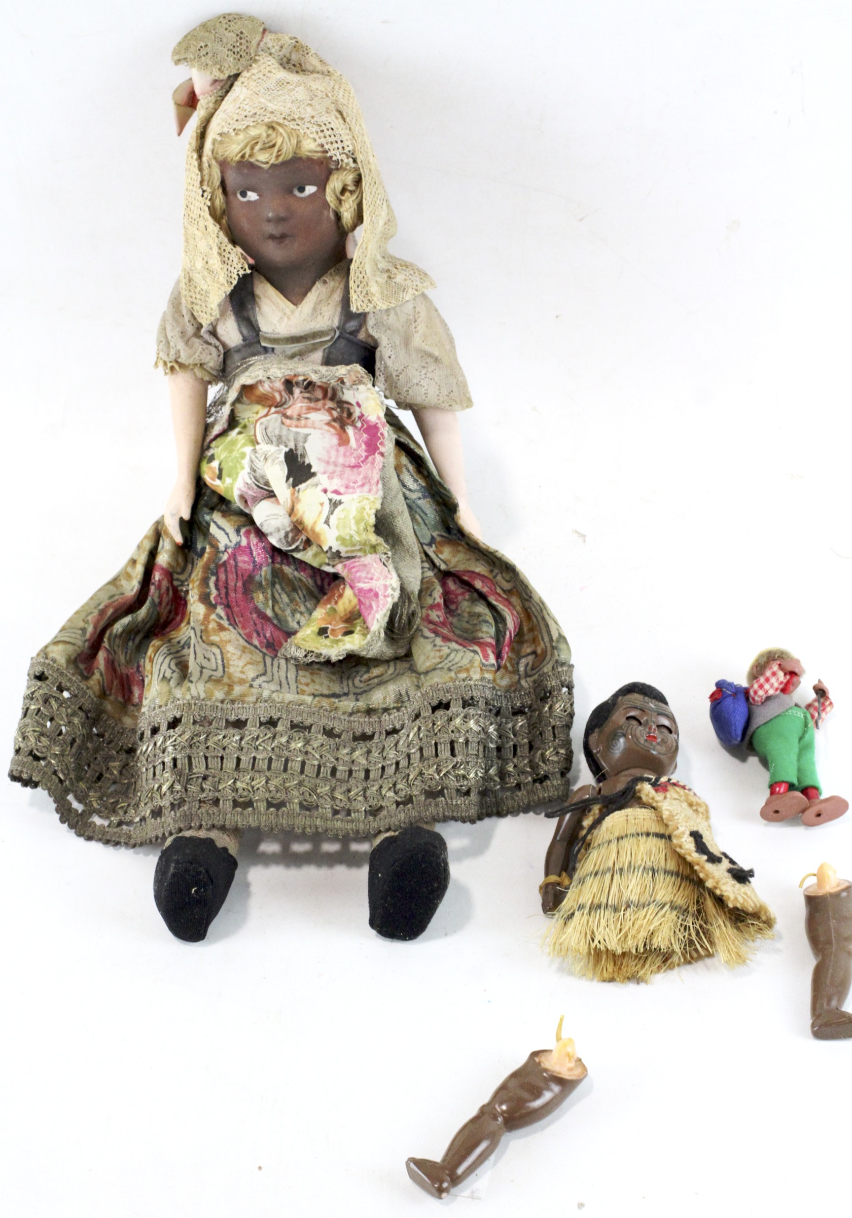 Three 20th century dolls, the larger example with plaster face and ...