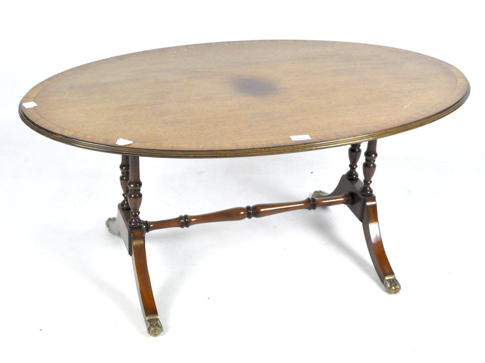 A mahogany Georgian style oval coffee table with inlaid details,