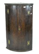 A Georgian oak corner cupboard,